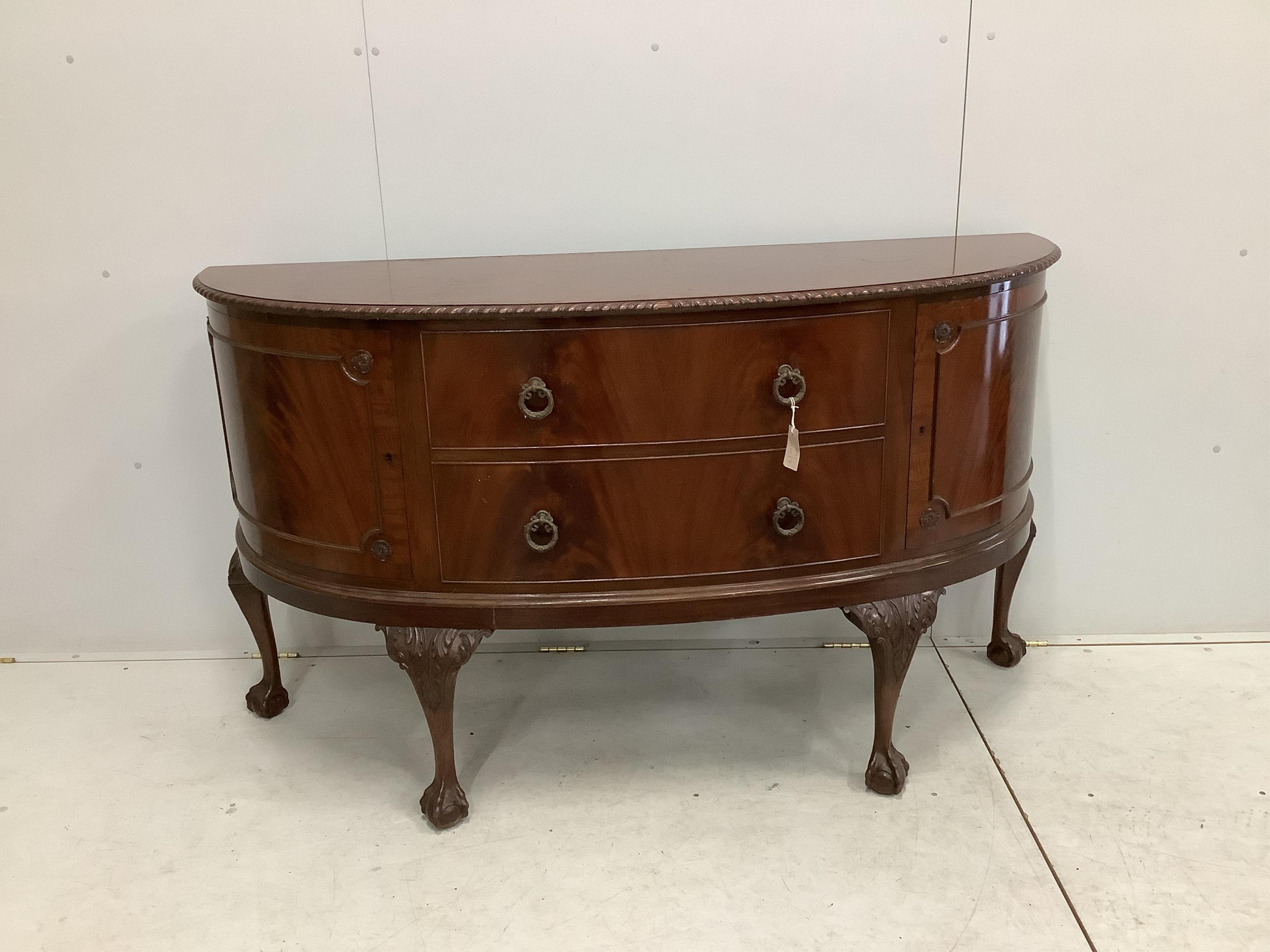 A Chippendale Revival mahogany dining suite comprising extending dining table, 210cm extended, two spare leaves, depth 106cm, height 75cm, bowfront sideboard and serving table, together with six dining chairs (two with a